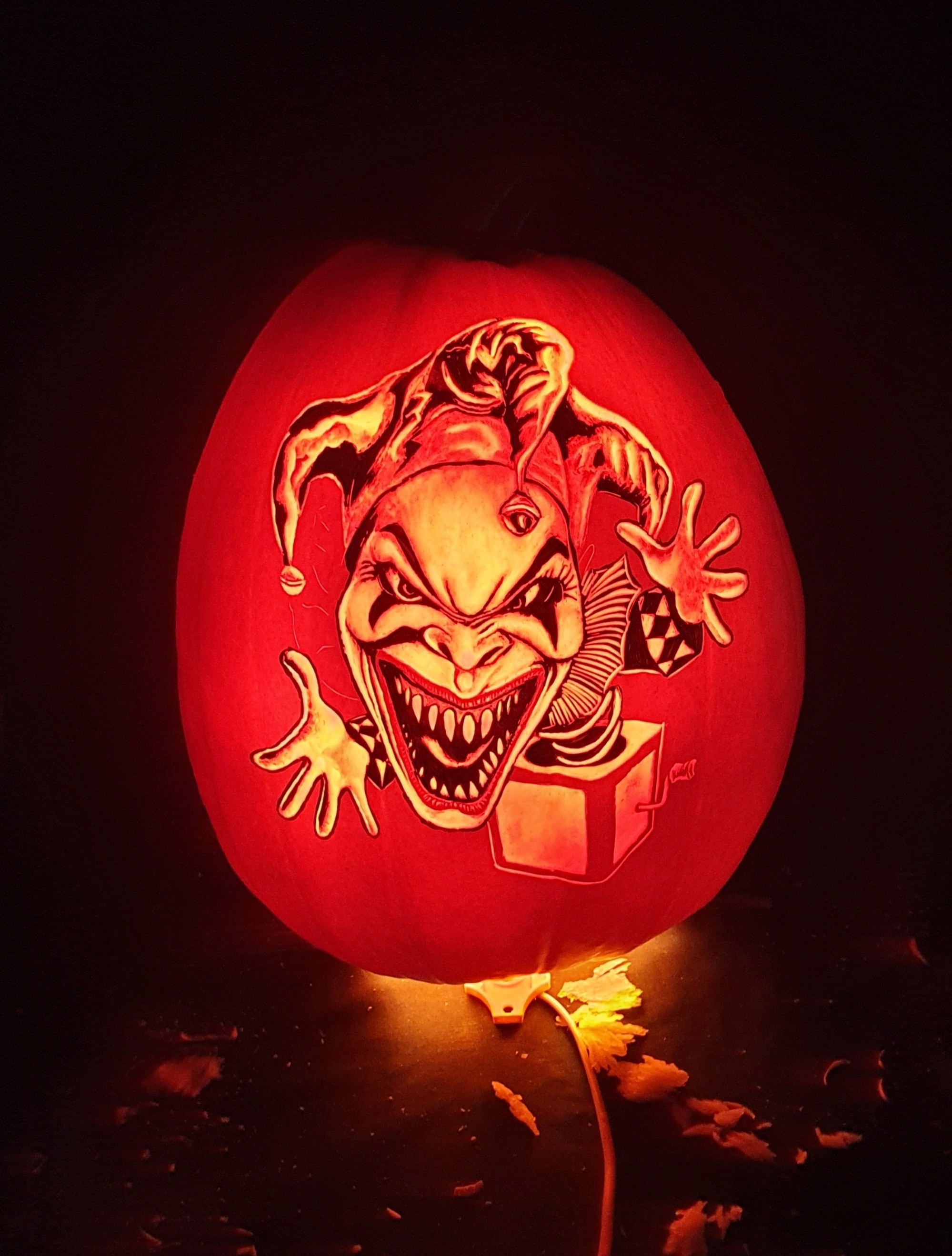 an evil jack in the box toy carved on a pumpkin