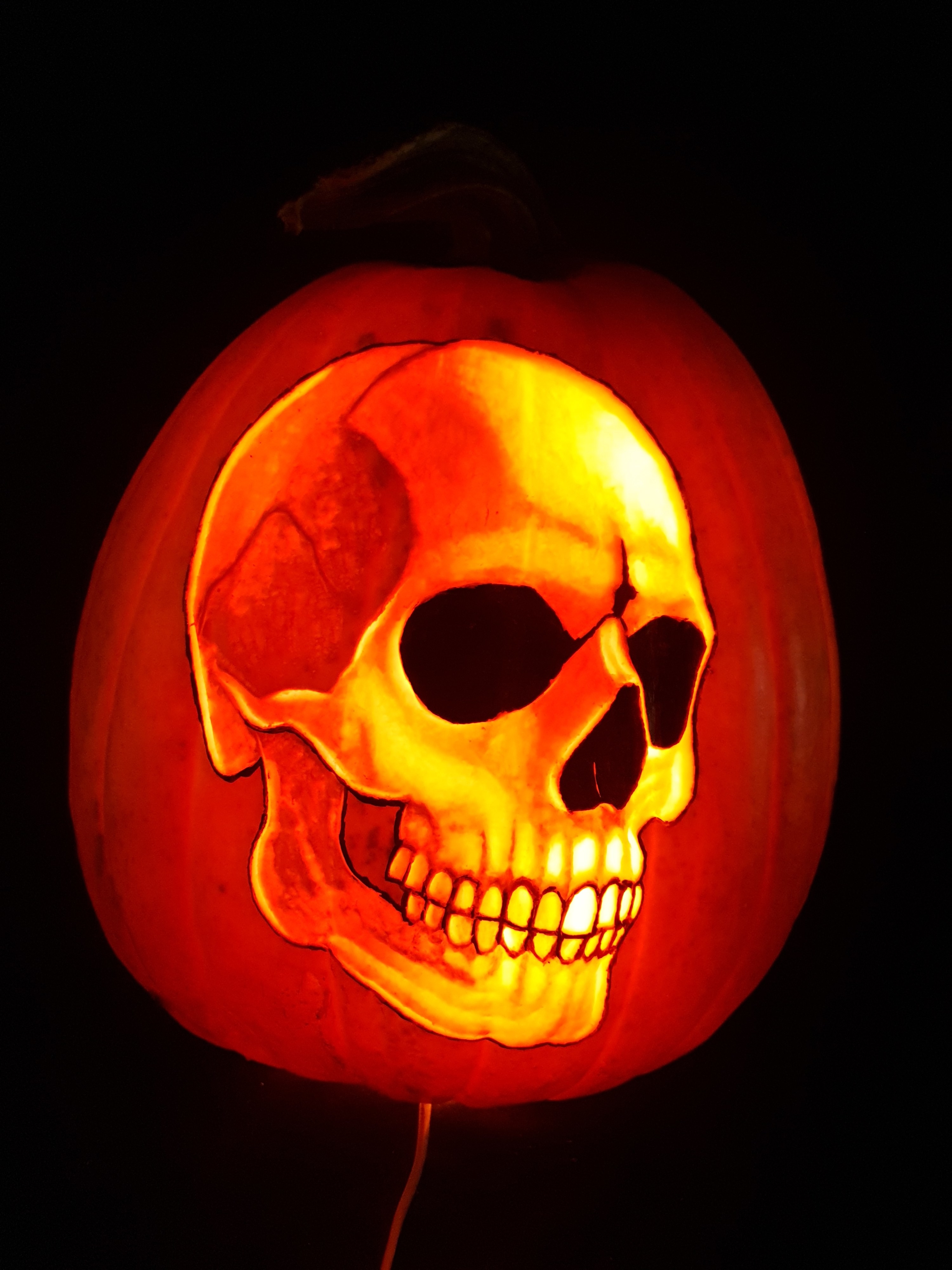 a skull carved on a pumpkin