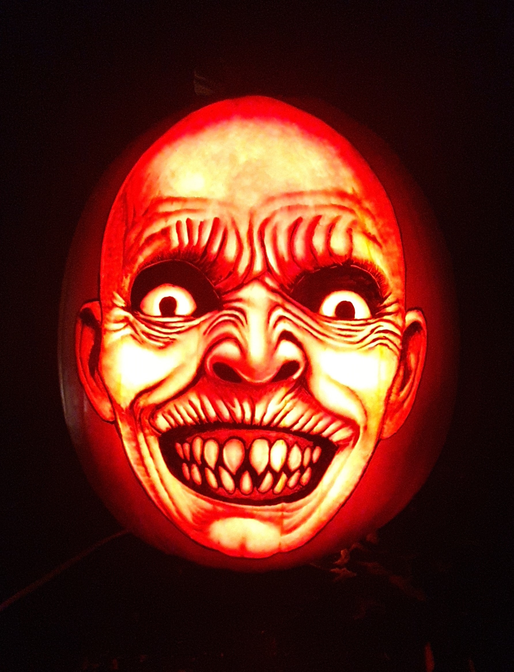 a scary face carved on a pumpkin
