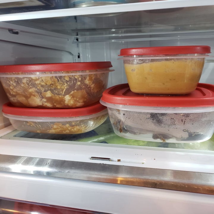 The set of clear containers with red lids in a reviewer's fridge