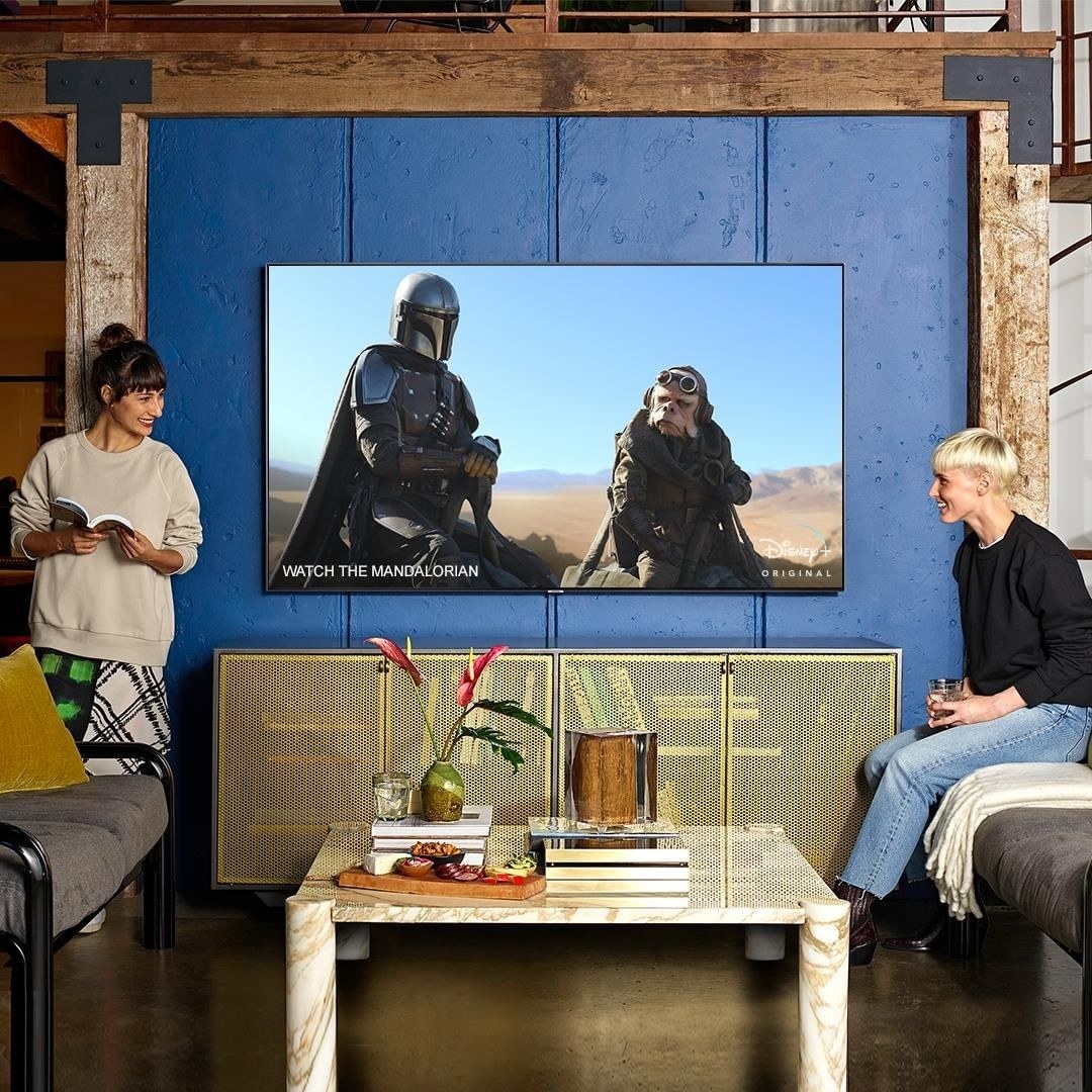 a pair of friends watching the mandalorian on their samsung high def smart tv
