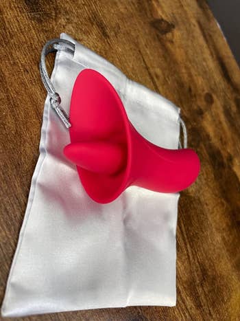 red vibrator from different angle displaying tongue attachment