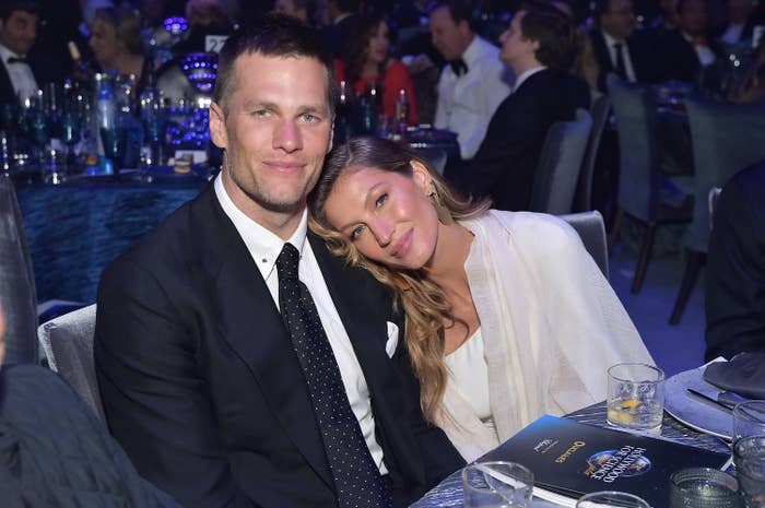 Gisele laying her head on Tom&#x27;s shoulder as they pose for a photo at a dinner event