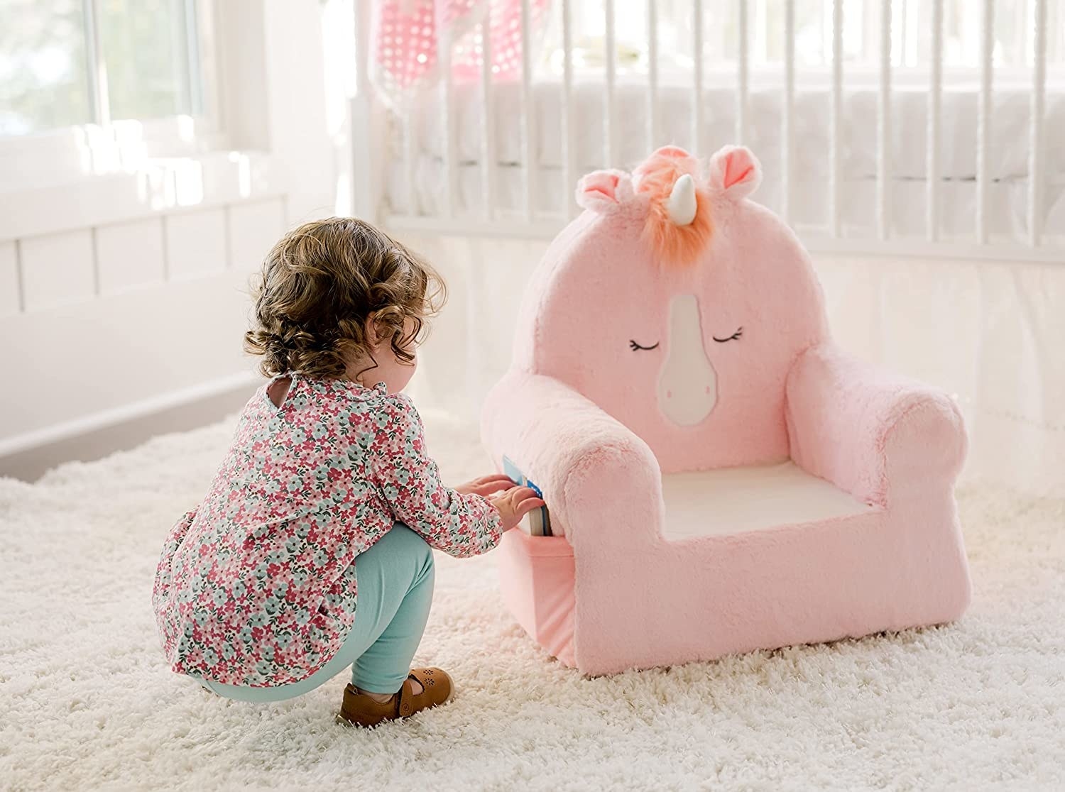 kid with unicorn plush chair