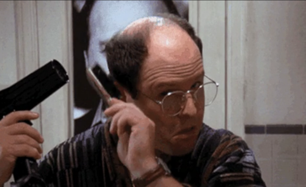 George Costanza from Seinfeld blow-drying his scant hair