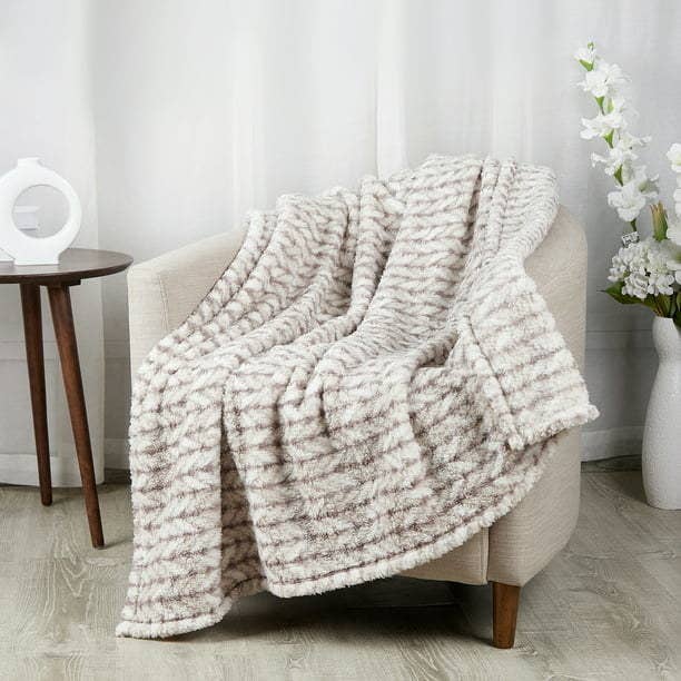 Sherpa throw blanket draped over an armchair