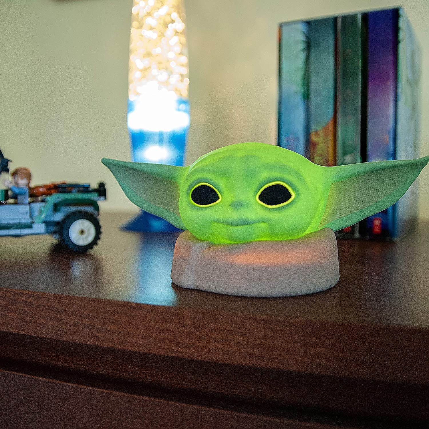 a gif of the baby yoda night light in the light and dark