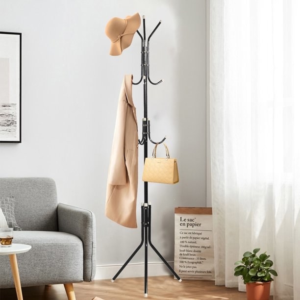 Coat hanger with hat, jacket and bag hanging on it