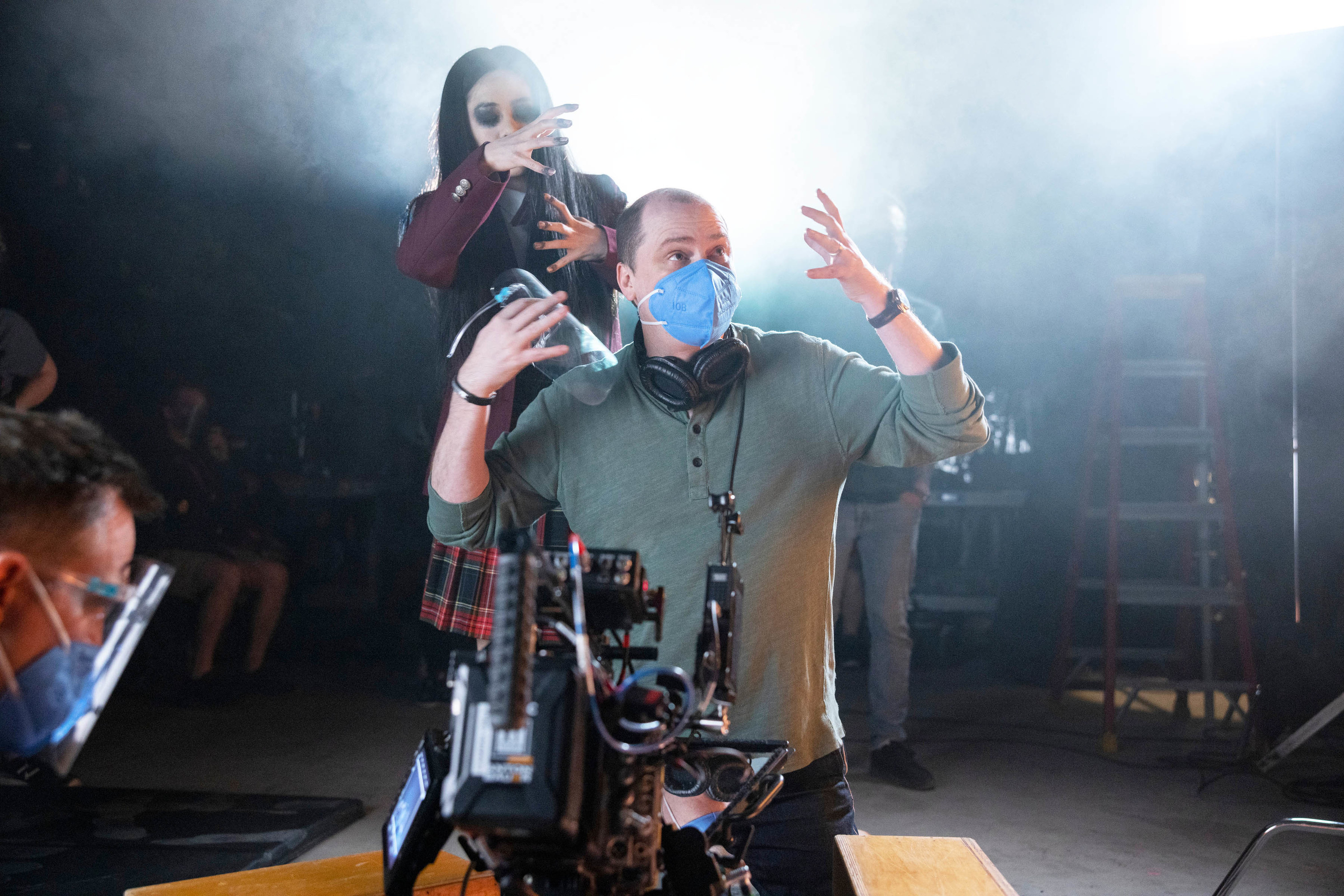 Mike directing a scene while wearing a face mask