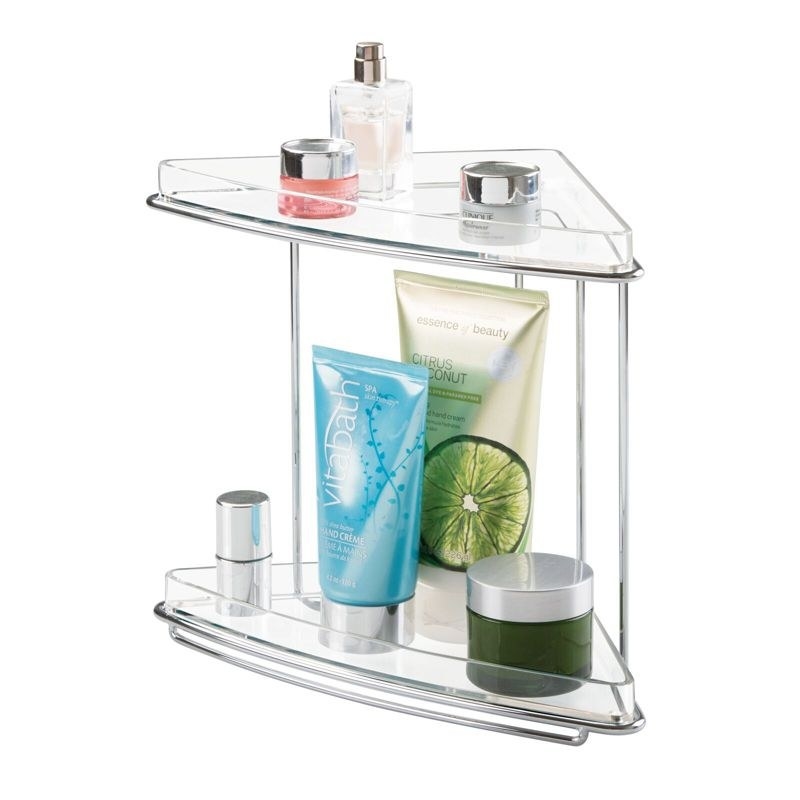 Metal corner shelf with two clear shelves, beauty products on both shelves