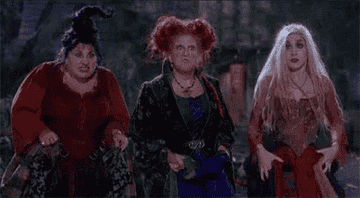 the sanderson sisters from hocus pocus screaming at a flashing light