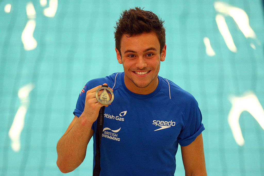 Tom Daley holding a medal