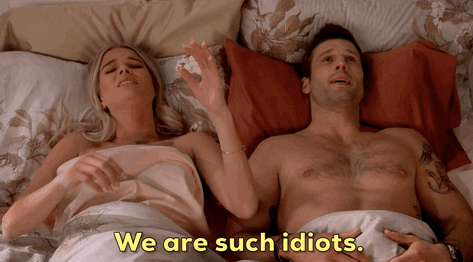 A couple laying in bed with the woman saying, &quot;We are such idiots.&quot;