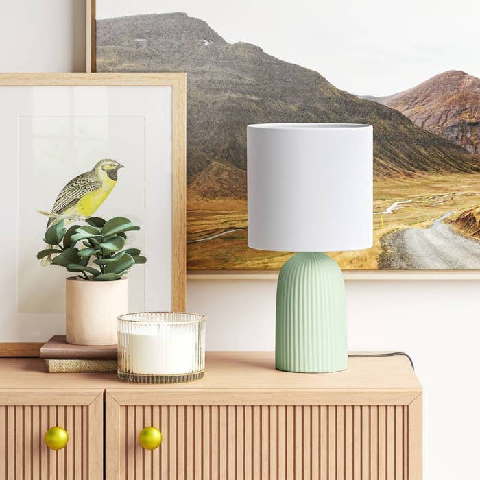 the teal lamp with a white shade