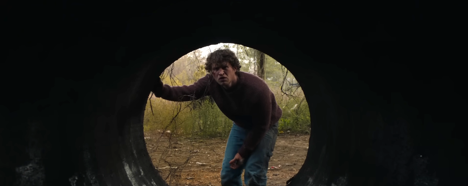 Corey looking in a sewer pipe
