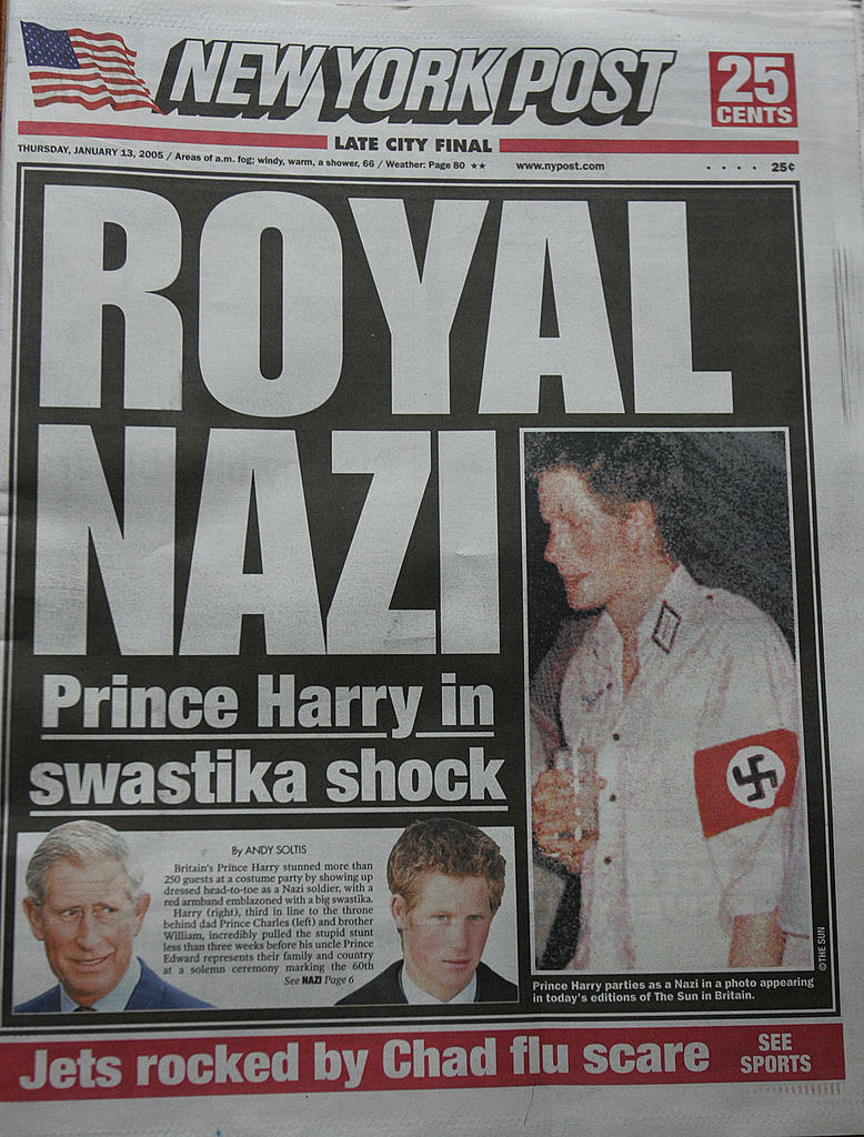 Headline: &quot;Royal Nazi, Prince Harry in swastika shock&quot; with a photo of Harry holding a drink while wearing the costume