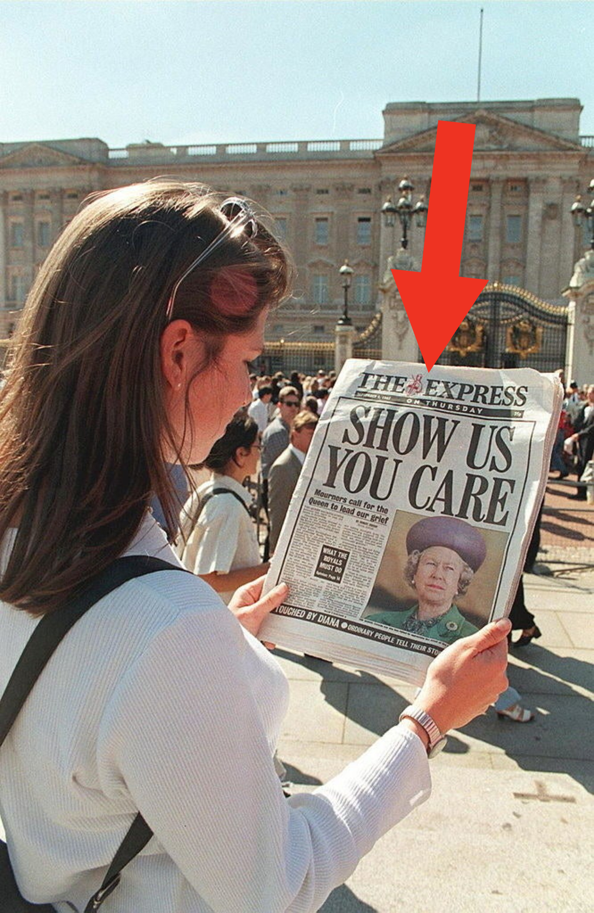 woman holding a newspaper with the queens face and headline reading, show us you care