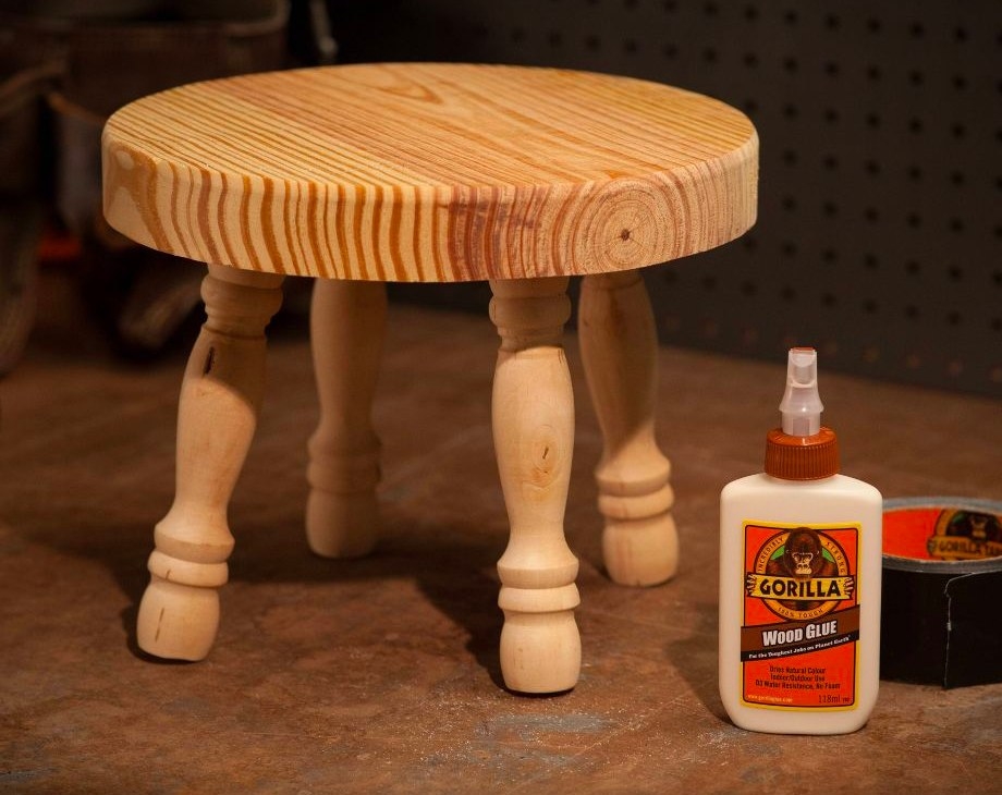 The wood glue next to a stool