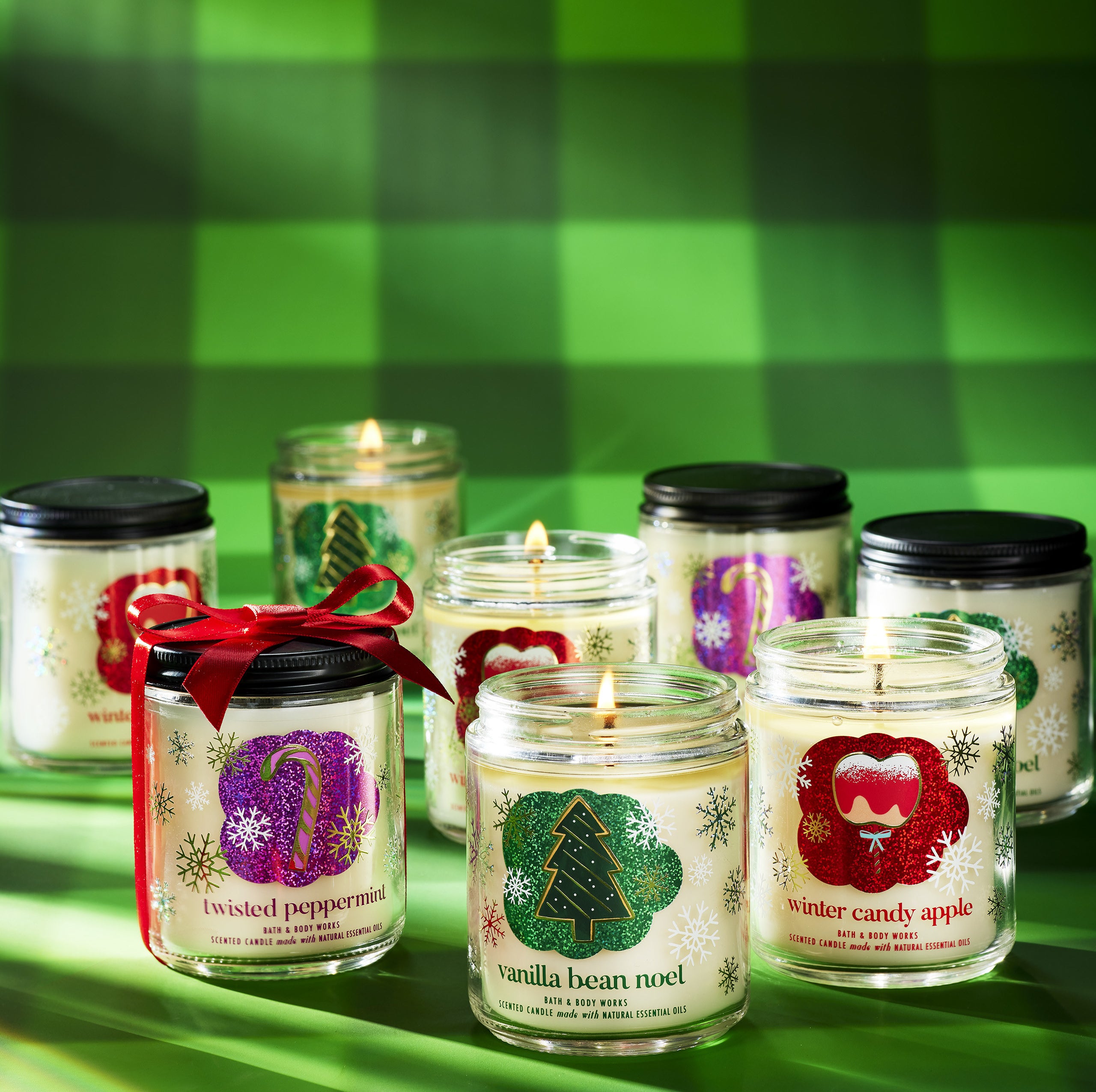 a bunch of holiday themed single-wick candles