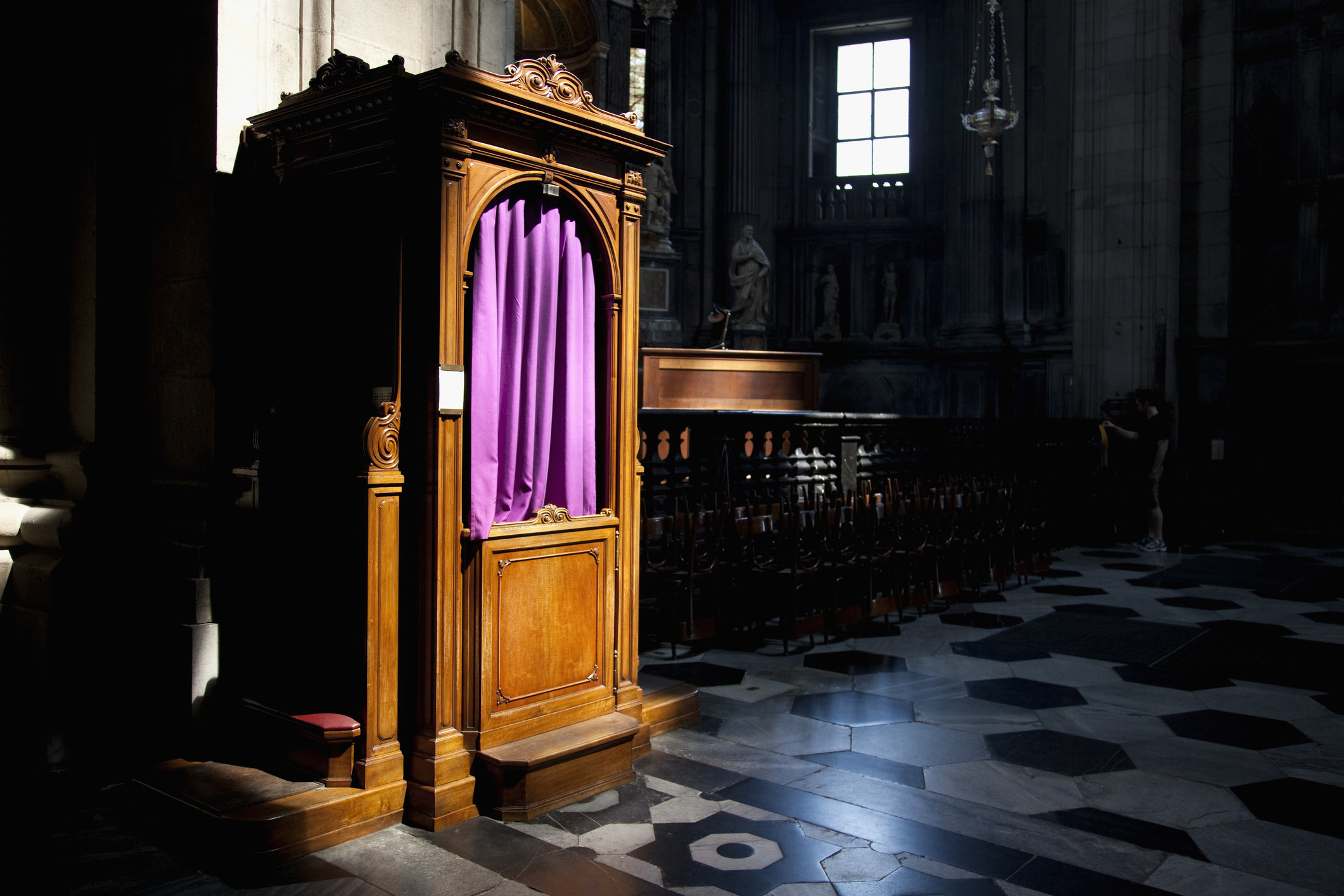 A confessional in a dimly lit church