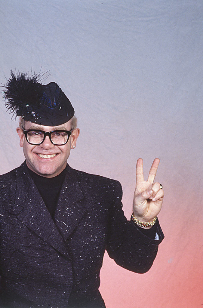 Elton John holding the peace sign