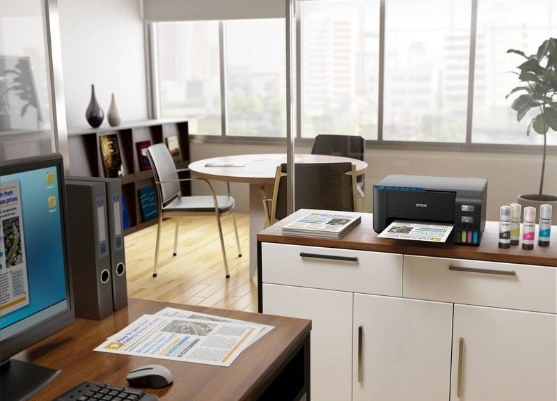 The printer sitting on desk with page siting in tray