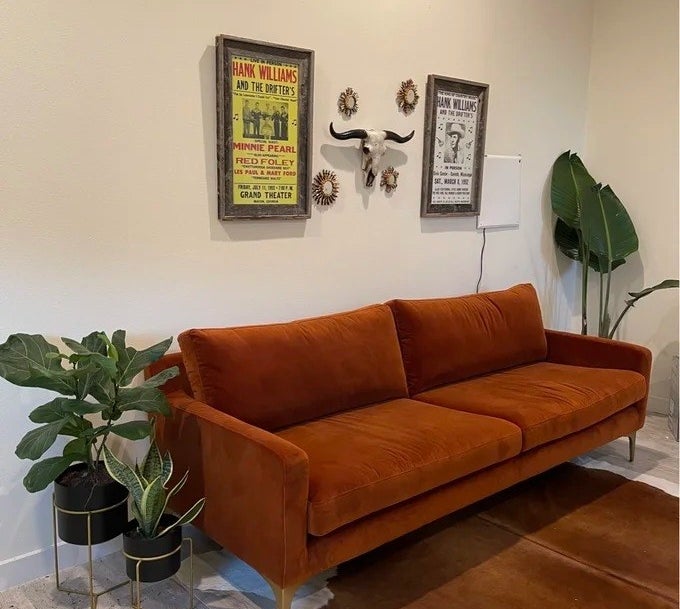 a reviewer photo of the rust colored couch