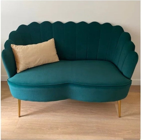 a reviewer photo of the teal loveseat