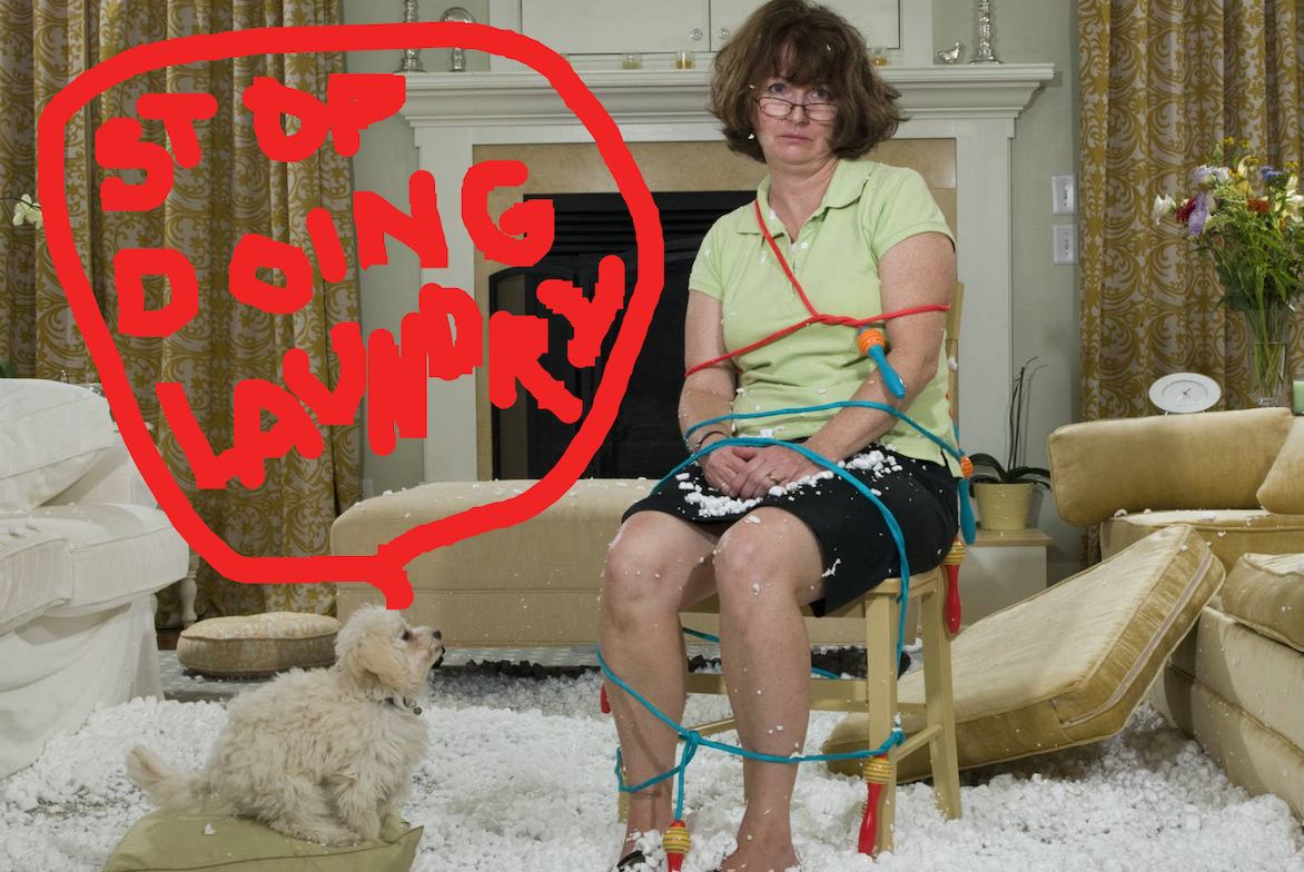 Woman sitting in a living room, tied up with a jump rope, with stuffing from her sofa cushions all over the floor, and a little dog looking at her with a comment bubble above it: &quot;Stop doing laundry&quot;