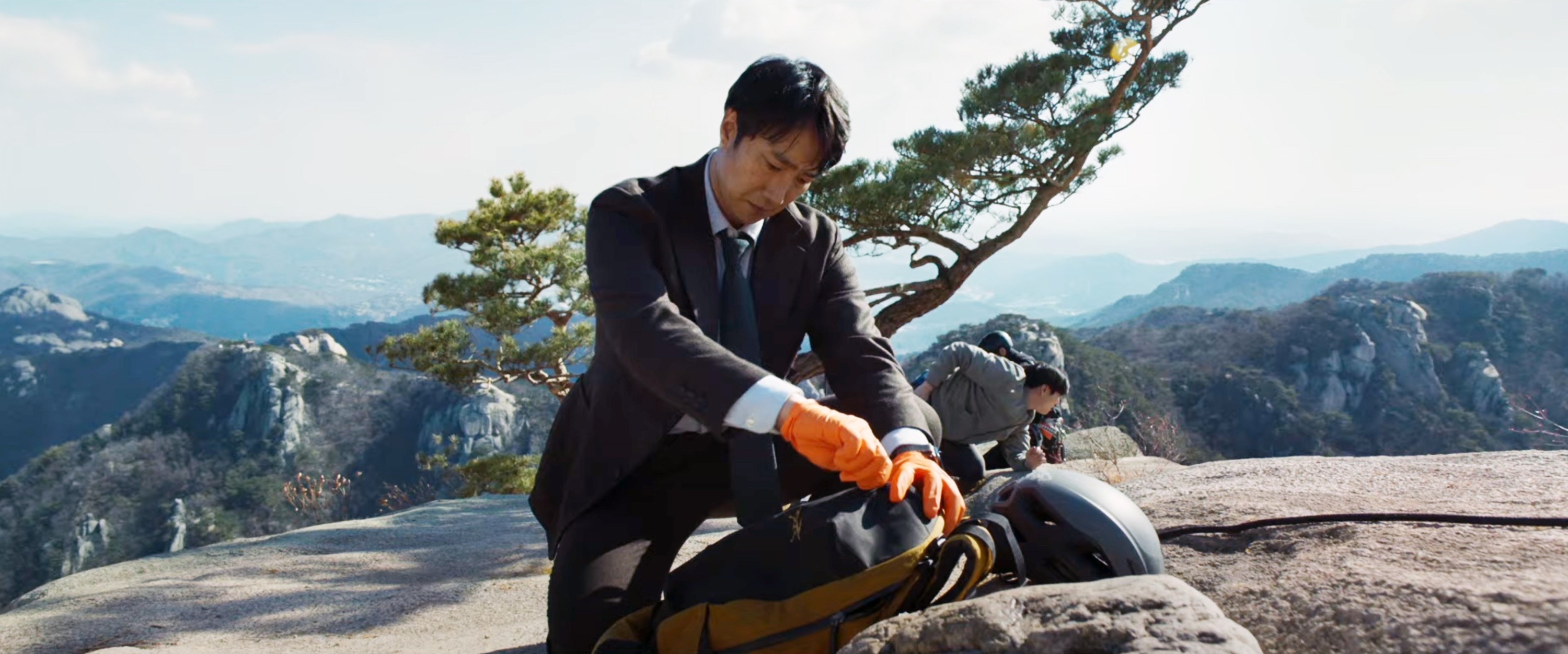 Hae-joon looking closer at the evidence on the mountaintop