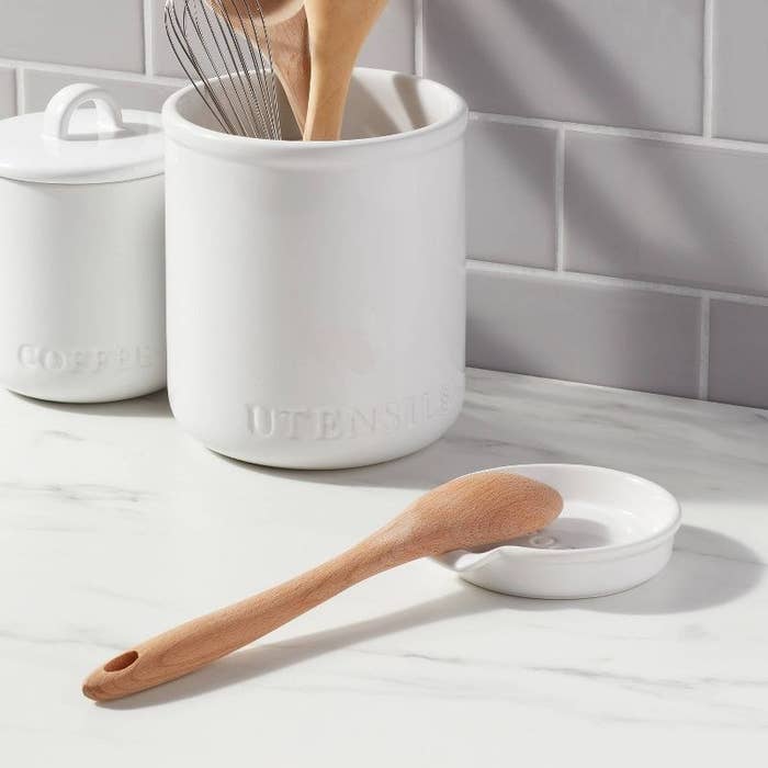 a wooden spoon on the stoneware spoon rest