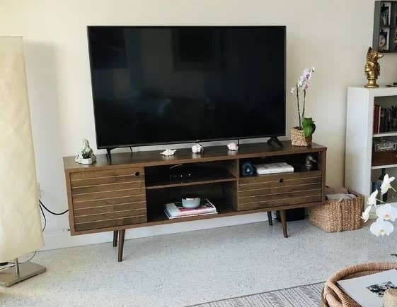 A brown TV stand in a reviewer&#x27;s home