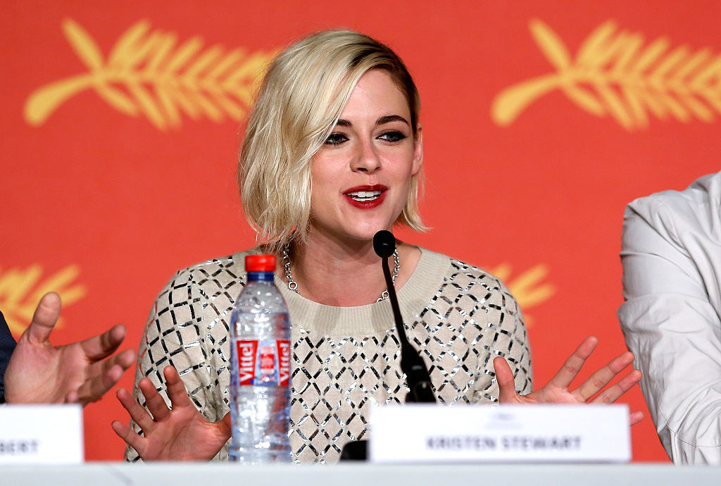 Kristen on a panel speaking into a microphone