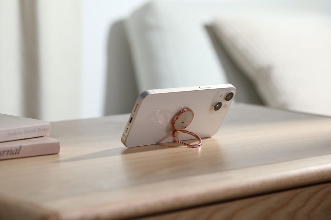 the magnetic ring phone holder propping up an iphone