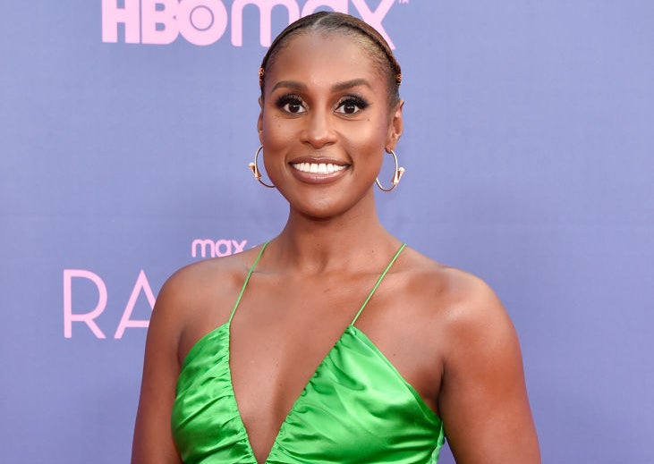 Issa smiling on the red carpet and wearing a spaghetti-strap halter top