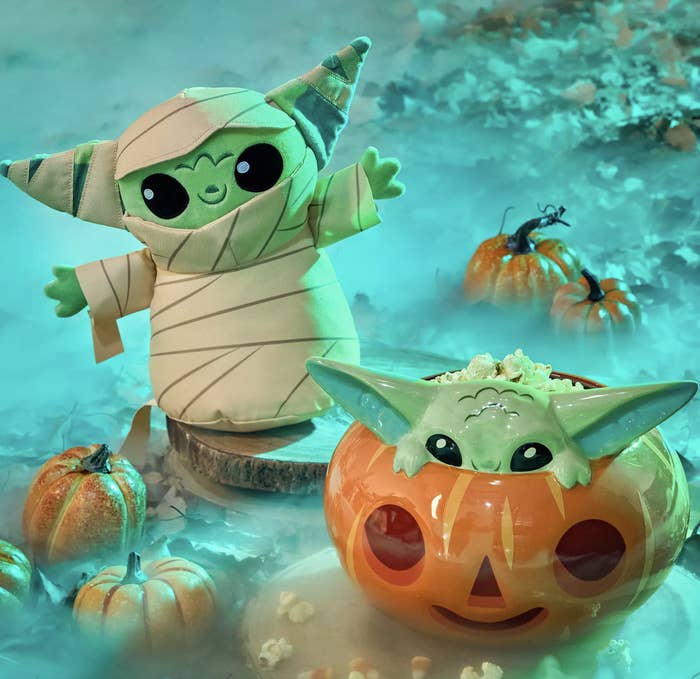 A Grogu mummy plush surrounded by pumpkins and fog