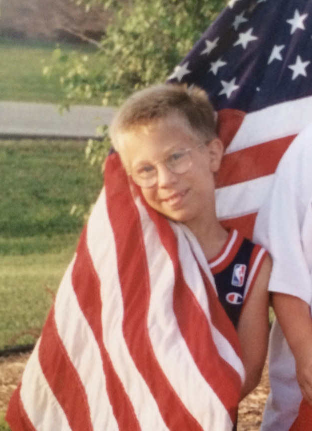 A boy wrapped in a US flag