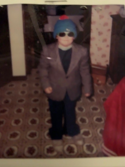 Blurry image of a child wearing a suit jacket