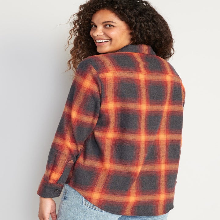 a model wearing the black and orange flannel