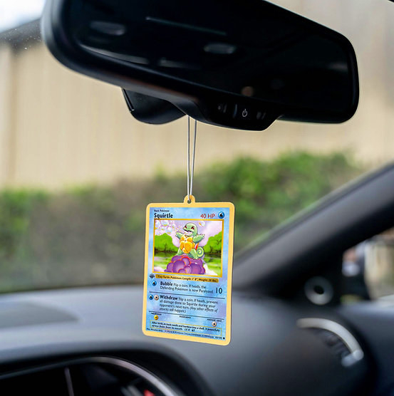a squirtle pokemon card hanging from a rearview mirror