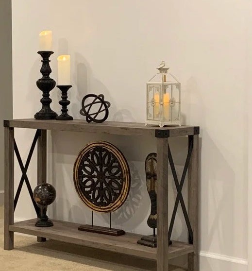 reviewer photo of the console table with home decor on it