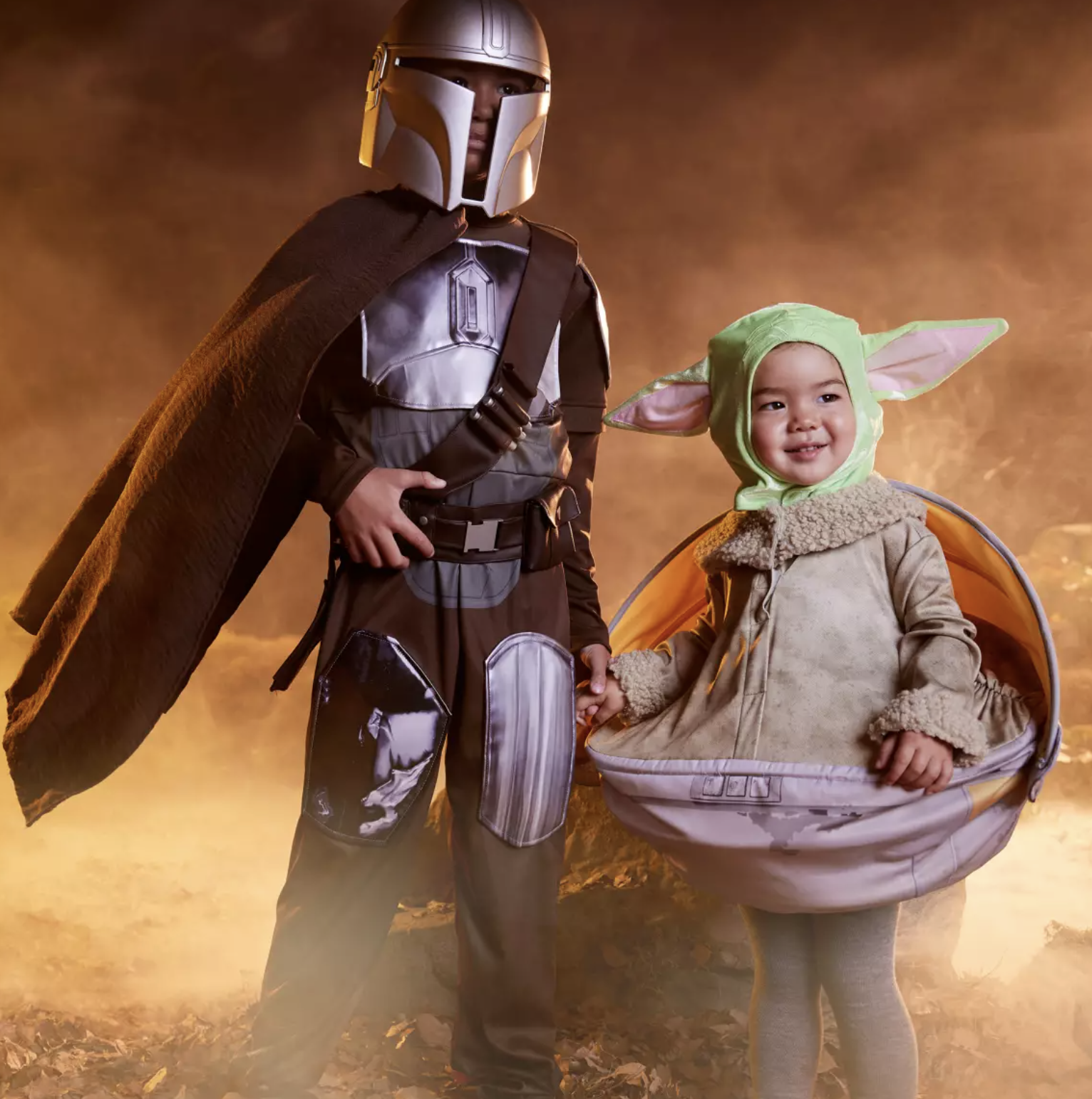 One child in a Mandalorian costume and the other in a Grogu costume
