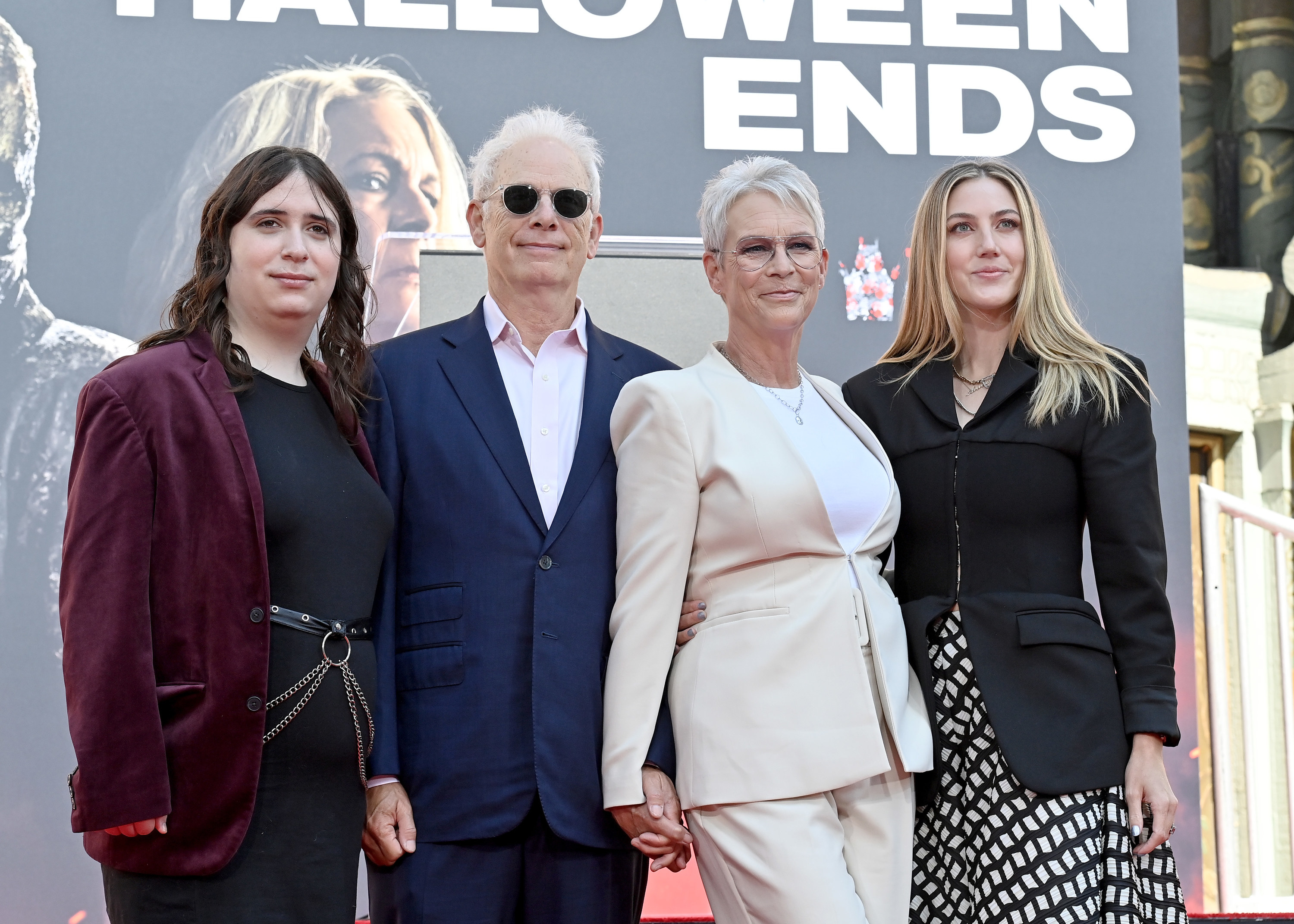 Jamie poses with her husband Christopher Guest, Ruby, and Annie