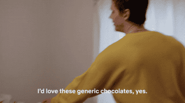 Tan from Queer eye saying &quot;I&#x27;d love these generic chocolates&quot; while being handed a box of chocolates with no label on them
