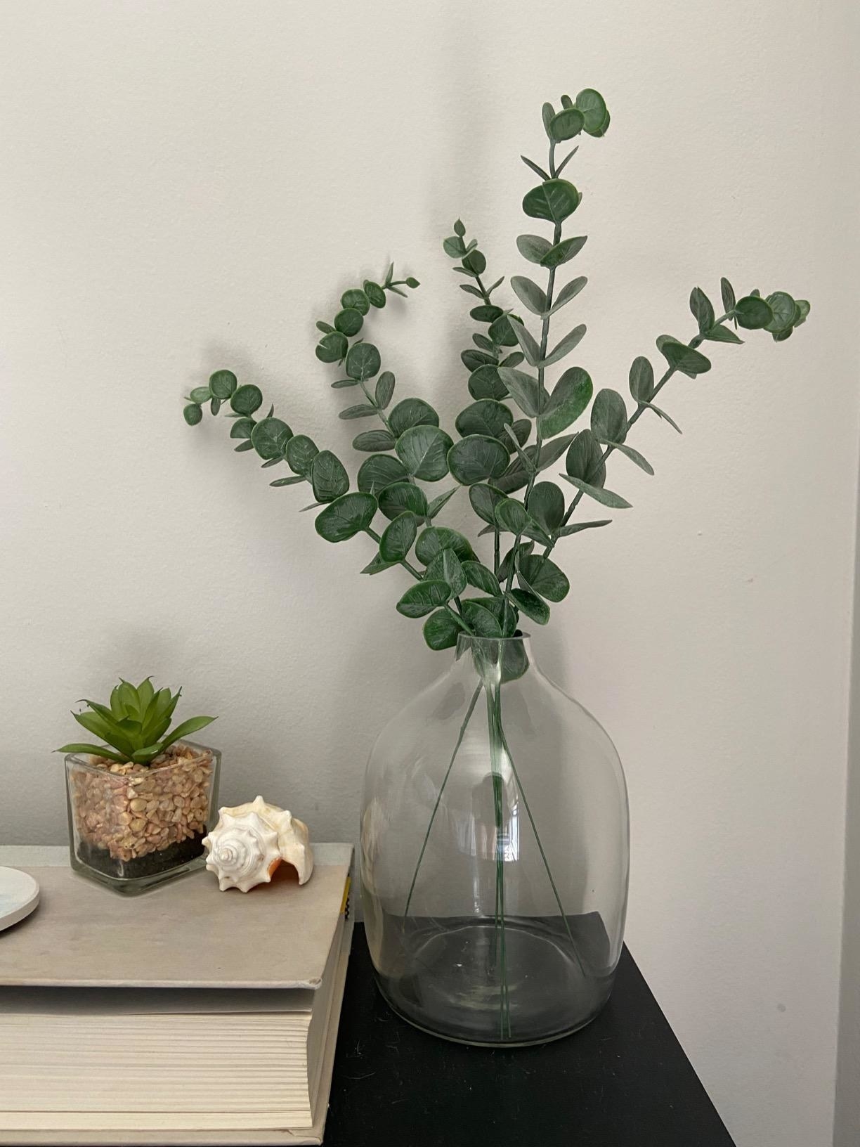 Reviewer&#x27;s faux Eucalyptus stems are shown in a vase