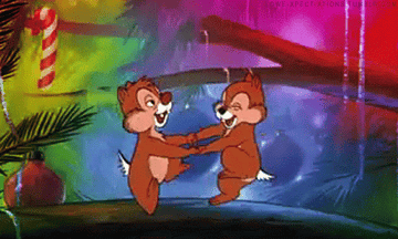 a gif of chip and dale dancing in a christmas tree