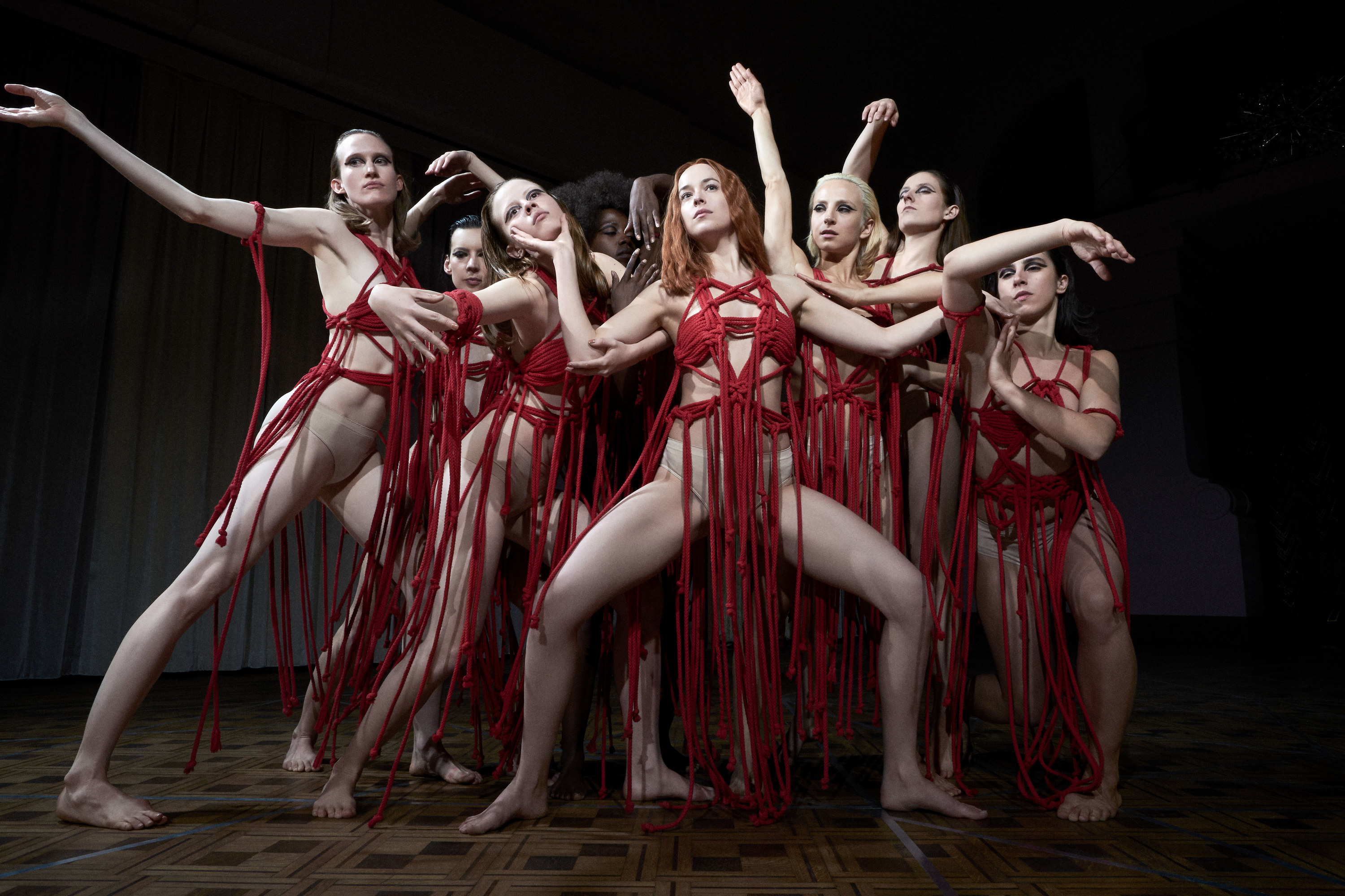 group of dancers with red rope made as their costumes
