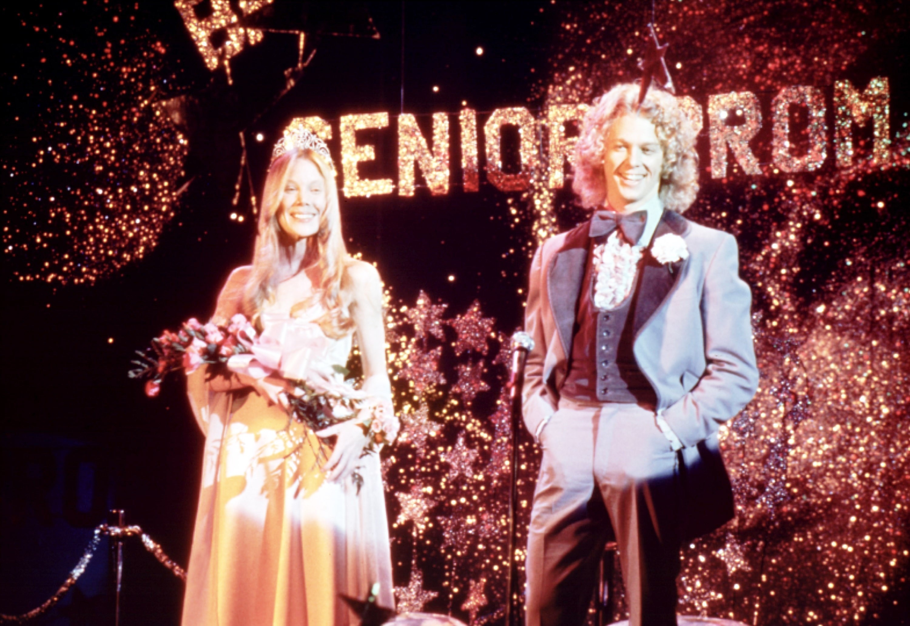 the prom king and queen on stage