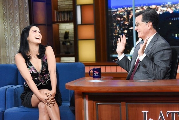 Camila laughing with Stephen Colbert during an interview