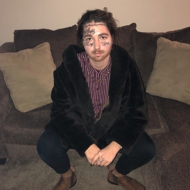 Someone dressed as Post Malone, with a bunch of hand-drawn tattoos on their face